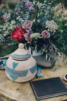 an arrangement of flowers and other items on a table