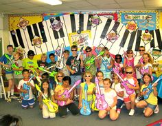 a group of children posing with musical instruments