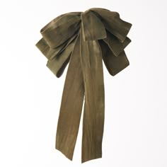 an olive green bow tie hanging on a white wall