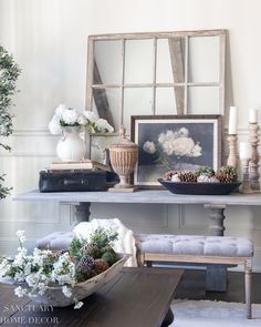 a living room filled with lots of furniture and flowers on top of a wooden table