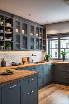 a kitchen with wooden floors and gray cabinets