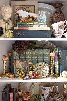 the shelves are filled with books, vases and other decorative items such as figurines