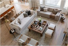 an aerial view of a living room with couches, chairs and tables in it