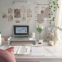 a laptop computer sitting on top of a white desk