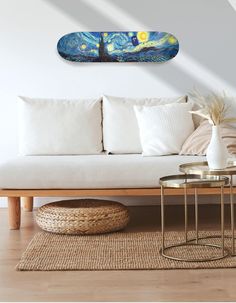 a living room with a white couch and wooden coffee table in front of the wall