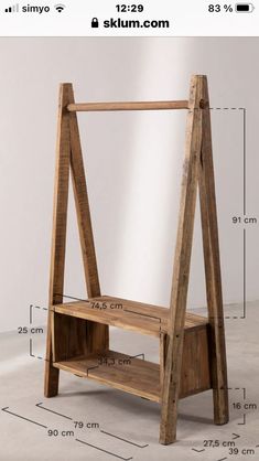 a wooden shelf with measurements for it to be placed on the floor, and in front of