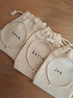 three small bags with personalized names on them