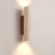 a wall mounted light on the side of a white wall with two lights attached to it