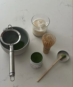 the ingredients are ready to be cooked in the pot and whisk on the counter