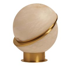 a white marble ball on a gold stand