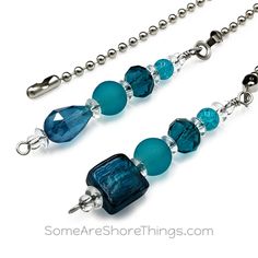 two necklaces with blue glass beads and silver balls