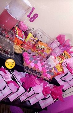 a table topped with lots of candy and candies next to a sign that says love