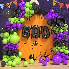 balloons and decorations are arranged in the shape of a boooo sign on a halloween themed backdrop