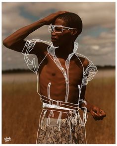 a man standing in the middle of a field with his hands on his head and wearing sunglasses