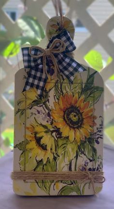 a tag with sunflowers painted on it