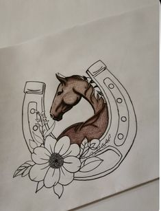 a drawing of a horse in a horseshoe with flowers on the side and a flower around it