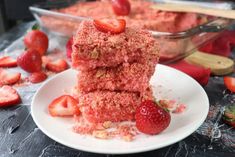 two pieces of cake on a plate with strawberries