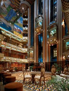 the interior of a hotel lobby decorated in art deco style with high ceilings and colorful tile flooring