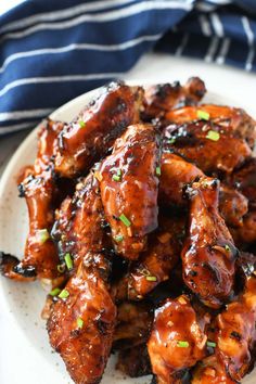 sweet and sticky apricot glazed chicken wings on a white plate with text overlay