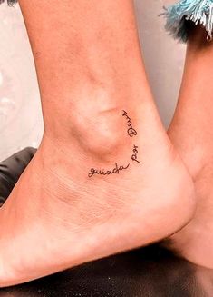 a woman's foot with the words love and strength written in cursive writing