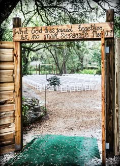 an open wooden gate with a sign on it