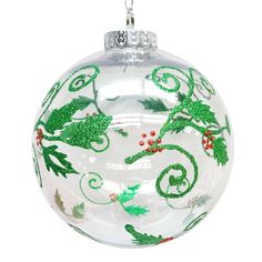 a glass ornament with green and red designs