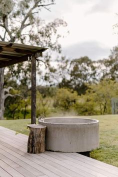 a concrete tub sitting on top of a wooden deck