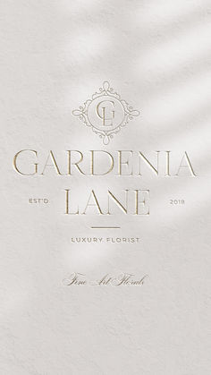 a white wall with the words gardinia lane written in gold foil on it