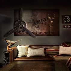 a living room filled with lots of furniture next to a wall mounted clock and fan