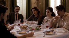 a group of people sitting around a dinner table