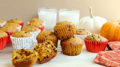 muffins with chocolate chips and pumpkins next to milk