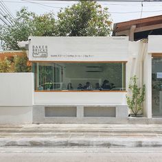 a white building sitting on the side of a road