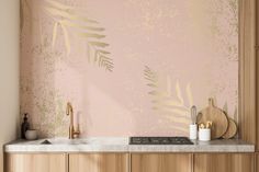 a kitchen with pink wallpaper and gold leaf stencils