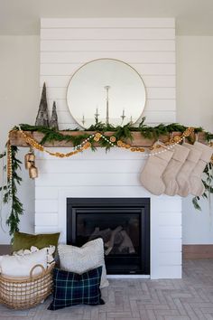 a fireplace decorated for christmas with stockings and stocking