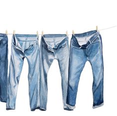 three pairs of blue jeans hanging on a clothes line, with one pair folded back to the side