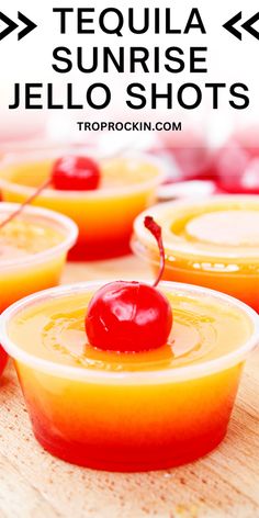 several small cups filled with jello and topped with a cherries garnish