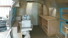 the inside of an airstrip with lots of storage and furniture in it's room