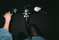 a person sitting in front of a microphone with their feet on the handlebars