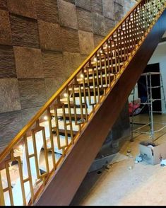 a stair case is being installed on the side of a wall in an unfinished room