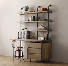 an industrial style shelf with books, lamps and other items on it in a living room