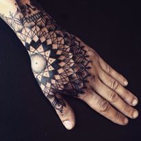 a person's hand with a tattoo on it