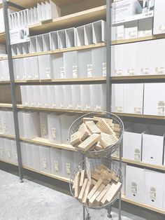 the shelves are full of boxes and file folders on metal racks with white bins