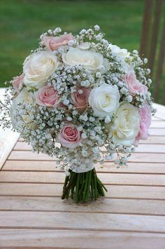 a bouquet of flowers sitting on top of a wooden table