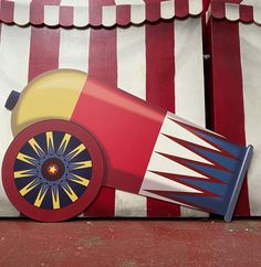 a red, white and blue carnival tent with a rocket ship painted on it