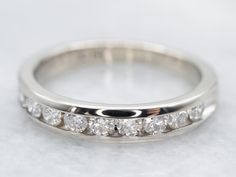 Crafted of fine white gold, this vintage band has a very rich feel and a wonderful, sophisticated profile. Channel settings never go out of style! The effect of one long row of diamonds, one band of glittering bright light, across the finger is always popular and always lovely. The sides of the ring completely encase the diamonds, keeping them safe and secure, which makes these rings easy to wear every day! Metal: 14K White GoldGem: 10 Diamonds totaling .45 Carats, VS-SI in Clarity, G-H in ColorWidth of Band: 3.5 mmHeight off Finger: 1.9 mmRing Size: 5.75Marks: “14K” Stamped on the inside band Profile Channel, Channel Set Diamond Band, Channel Ring, Garnet Ring Vintage, Amethyst Cocktail Ring, White Gold Diamond Band, Gold Diamond Band, Tanzanite Ring, Diamond Cocktail Rings