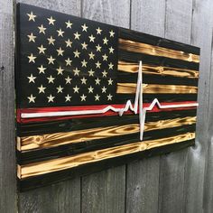 an american flag painted on the side of a wooden fence with a stethoscope