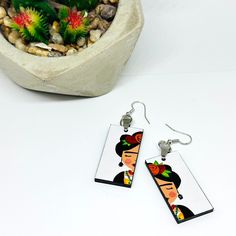 These stunning hand painted Little Frida earrings are a charming and unique work of art. We utilized top-notch acrylic paint and a protective gloss coat to ensure its long-lasting beauty. Lightweight and one-of-a-kind, they make a perfect gift for someone special. Size: 3/4 (.75) Inch x 1.5 Inch each. • GET IT FAST!Get it fast! Ready to ship on 1 to 3 business days. • ORDER NOW!Limited Quantities / Limited Edition. • FREE GIFT BOX INCLUDED!Get a Free Gift Box with any order. Thank you for shopping with us!____________________________ * Handmade/Hand Painted Product. Colors/Designs might slightly vary from actual. Our items are studio produced and our process is genuine and full of love and care. Any item you purchase is one of a kind. There are no two items in our shop that are exactly the Hand Painted White Resin Earrings, Artistic Hand Painted Earrings, Artistic Hand Painted White Earrings, White Hand Painted Artisan Earrings, Artsy White Resin Earrings, Mdf Earrings Hand Painted, Artistic White Resin Earrings, Adjustable Artistic Resin Earrings, Traditional Hand Painted Dangle Earrings