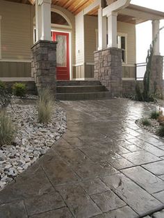 a stone walkway leading to a red door