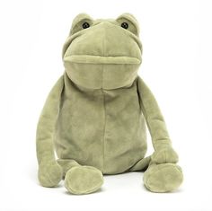 a frog stuffed animal sitting up against a white background