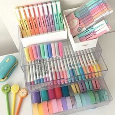 several plastic containers filled with different colored pens